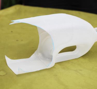 A milk carton bottle on a table with the bottom cut off